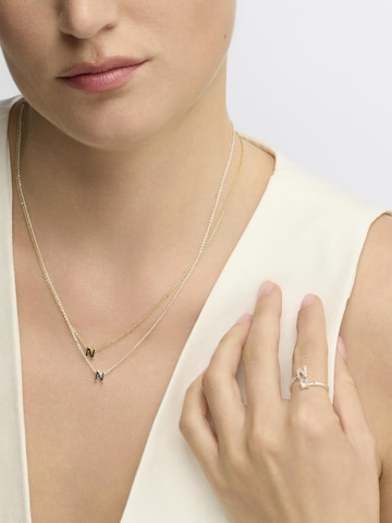 Luxenter Halsband 'N' i guld: framsida