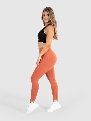 Smilodox Skinny Sportbroek 'Amaze Scrunch' in Oranje