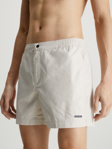 Calvin Klein Swimwear Board Shorts in Beige: front