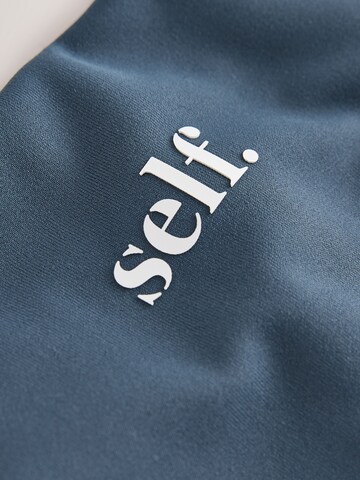 évasé Pantalon de sport self. en bleu