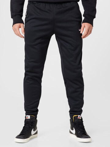 NIKE Tapered Workout Pants in Black: front