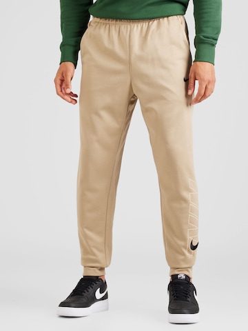 NIKETapered Sportske hlače - zelena boja: prednji dio