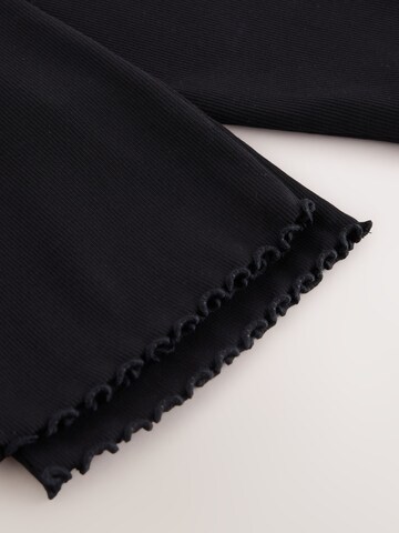 Next - Acampanado Leggings en negro