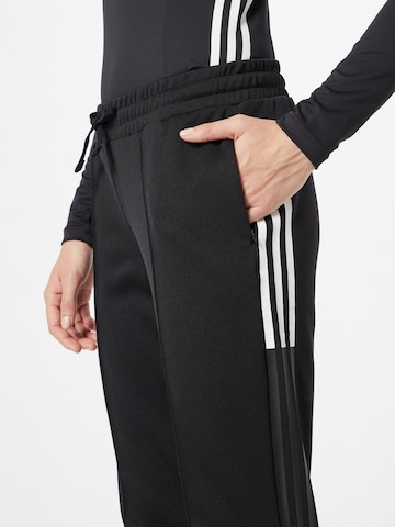 ADIDAS SPORTSWEAR Tapered Urheiluhousut 'Tricot' värissä musta