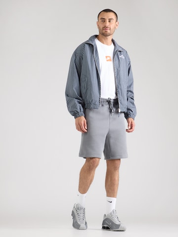 Nike Sportswear Lużny krój Spodnie 'TECH FLC' w kolorze szary