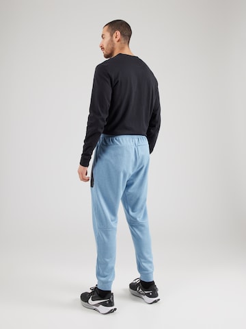 Effilé Pantalon de sport NIKE en bleu