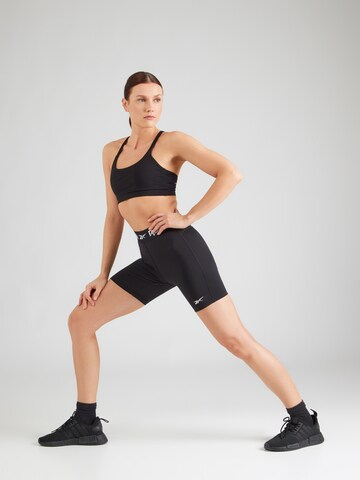 Reebok Skinny Sportnadrágok 'ID TRAIN' - fekete