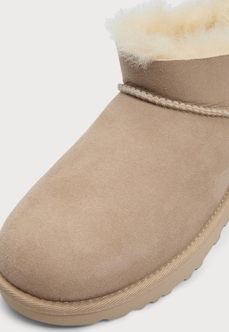 bēšs UGG Klasiski zābaki 'Ultra Mini Bailey Bow'