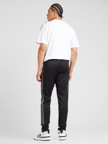 ADIDAS ORIGINALSTapered Hlače 'Adicolor' - crna boja