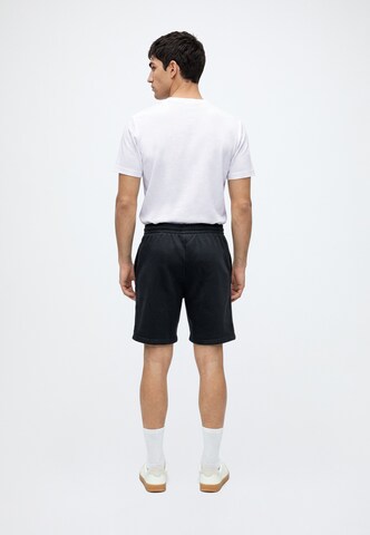 Karl Kani - regular Pantalón 'Signature' en negro