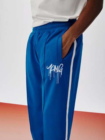 ABOUT YOU x Kingsley Coman Regular Trousers 'Kian' in Blue