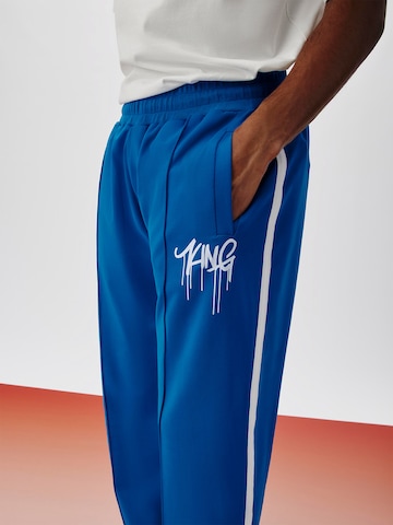 ABOUT YOU x Kingsley Coman Regular Trousers 'Kian' in Blue