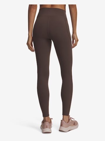 UNDER ARMOUR Skinny Sportbroek 'Motion' in Bruin