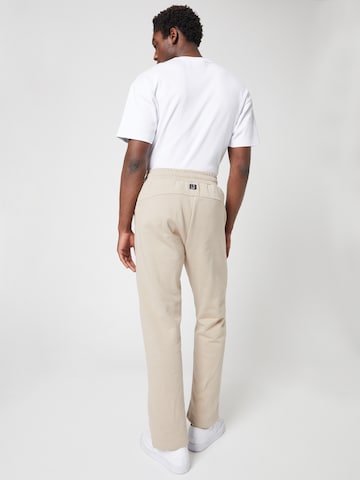 ABOUT YOU x Louis Darcis Loose fit Trousers in Beige