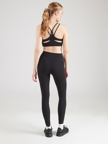 UNDER ARMOUR Skinny Športne hlače 'Motion' | črna barva