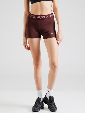 Skinny Pantalon de sport NIKE en violet : devant