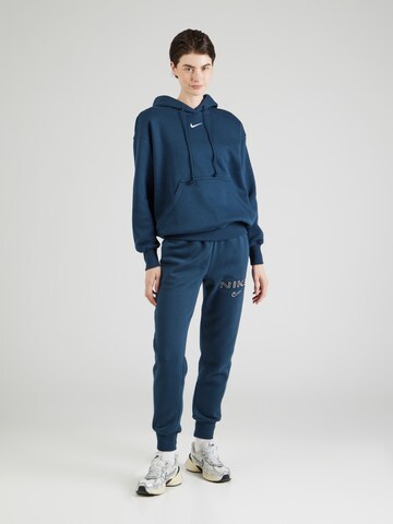 Nike Sportswear Zwężany krój Spodnie 'PHNX FLC' w kolorze niebieski