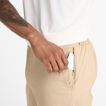 Regular Pantalon chino 'Athletics Standard Tapered' new balance en beige