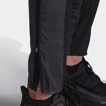 ADIDAS SPORTSWEAR Regular Workout Pants 'Own The Run Astro' in Black