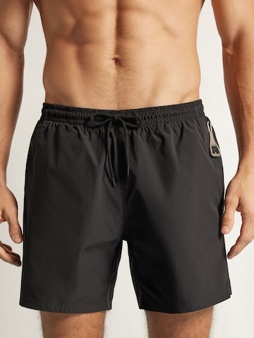 IUMAN Intimissimi Swim Trunks in Black: front