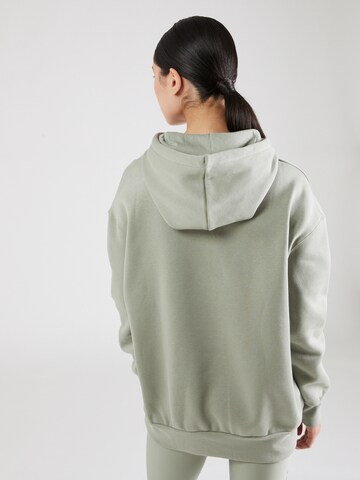 UNDER ARMOUR - Sweatshirt de desporto em verde