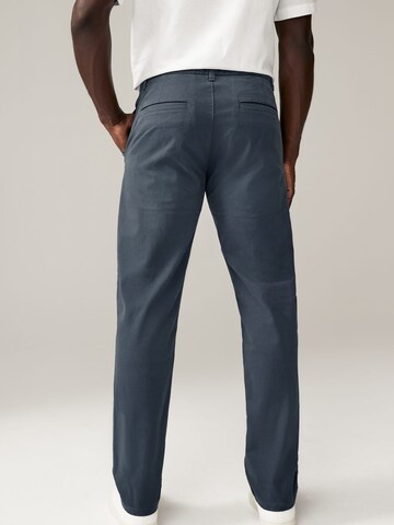 Next Slimfit Chinohousut värissä sininen