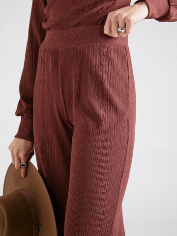 ABOUT YOU Loose fit Trousers 'Emina' in Brown