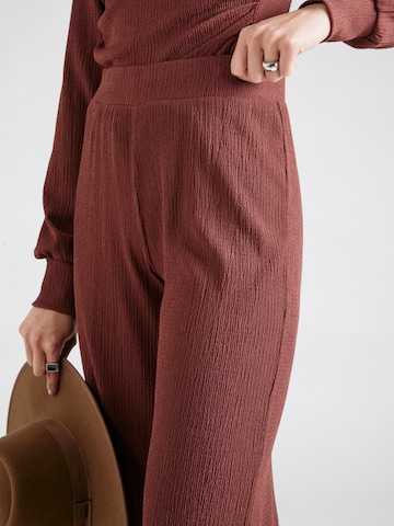 ABOUT YOU Loose fit Trousers 'Emina' in Brown