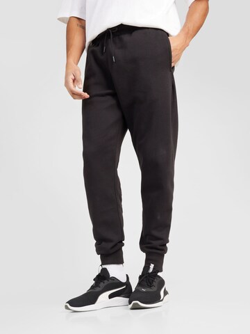 PUMA - Tapered Pantalón deportivo 'Posterize 2.0' en negro: frente