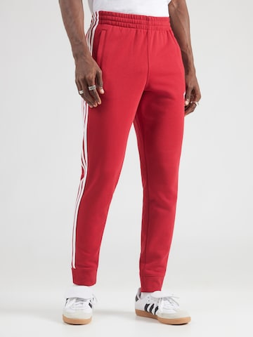 ADIDAS ORIGINALS - Tapered Calças em vermelho: frente