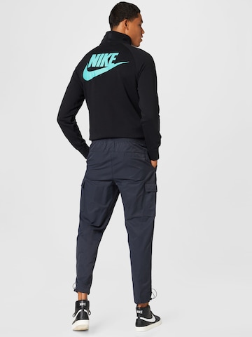 Nike Sportswear Tapered Hose 'REPEAT' in Schwarz