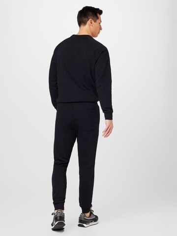 PEAK PERFORMANCE Tapered Trousers in Black