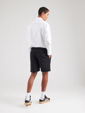 Karl Kani Regular Trousers in Black