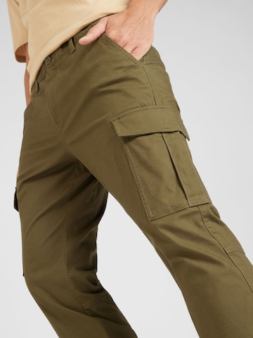 žalia Tommy Jeans Standartinis Laisvo stiliaus kelnės 'AUSTIN'