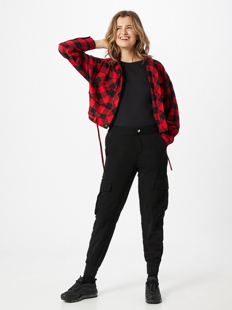 Woman wearing black cargo pants with a plaid shacket