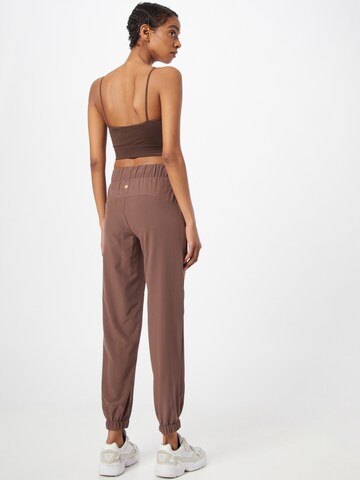 Athlecia Tapered Sports trousers 'Austberg' in Brown