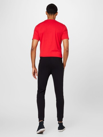 Tapered Pantaloni di Champion Authentic Athletic Apparel in nero