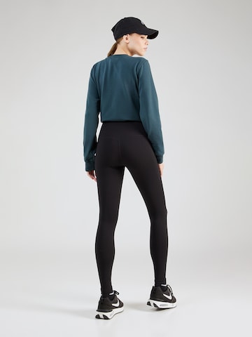 Skinny Pantaloni sportivi 'UNIVER' di NIKE in nero