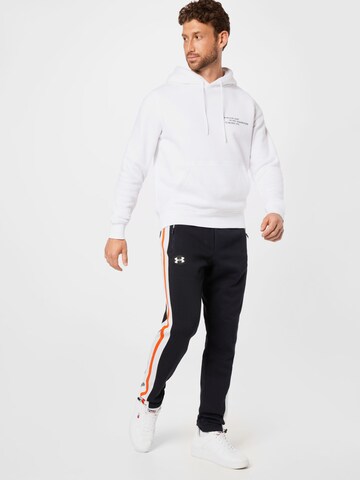 UNDER ARMOUR Tapered Sports trousers in Black