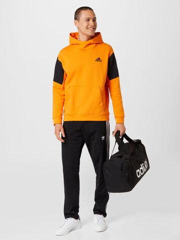 ADIDAS SPORTSWEAR - Sweatshirt de desporto em laranja