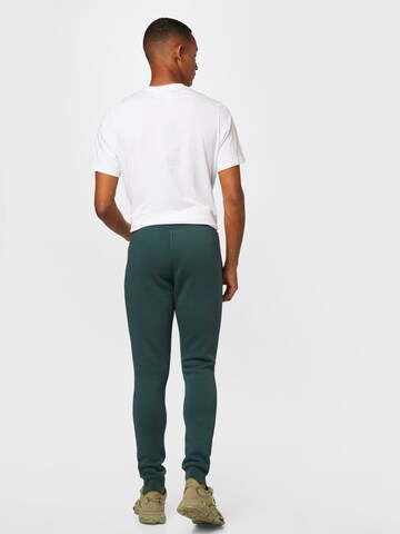 ADIDAS ORIGINALS Tapered Trousers 'Adicolor Essentials Trefoil' in Green