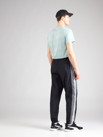 UNDER ARMOUR - Tapered Pantalón deportivo en negro