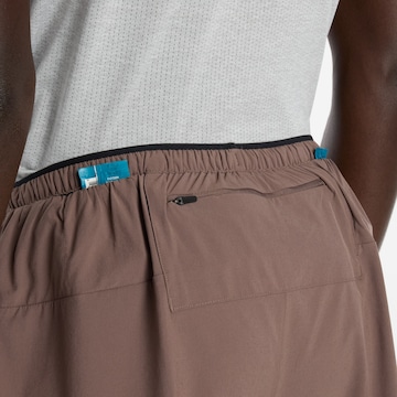 new balance Loosefit Sportbroek 'Essential' in Bruin