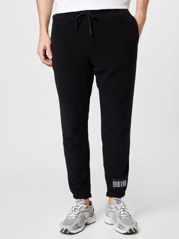 Trendyol Tapered Pants in Black: front