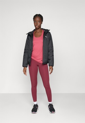 PUMA Skinny Sports trousers in Red