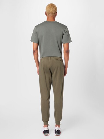 UNDER ARMOUR Tapered Sporthose in Grün