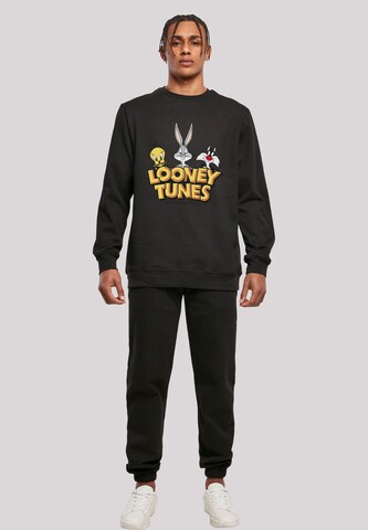F4NT4STIC Sweatshirt 'Looney Tunes Group Faux Pocket' in Schwarz