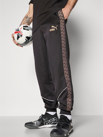 Effilé Pantalon de sport 'KING Anthem' PUMA en noir