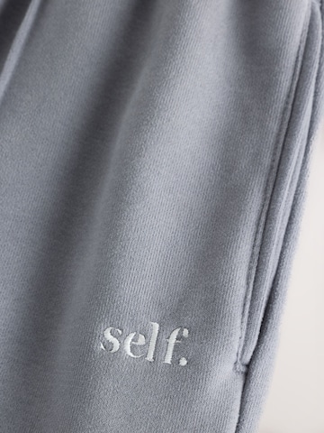 Wide leg Pantaloni sportivi di self. in grigio