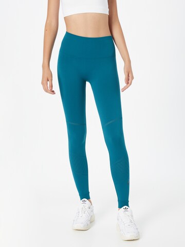 Skinny Pantalon de sport ASICS en vert : devant